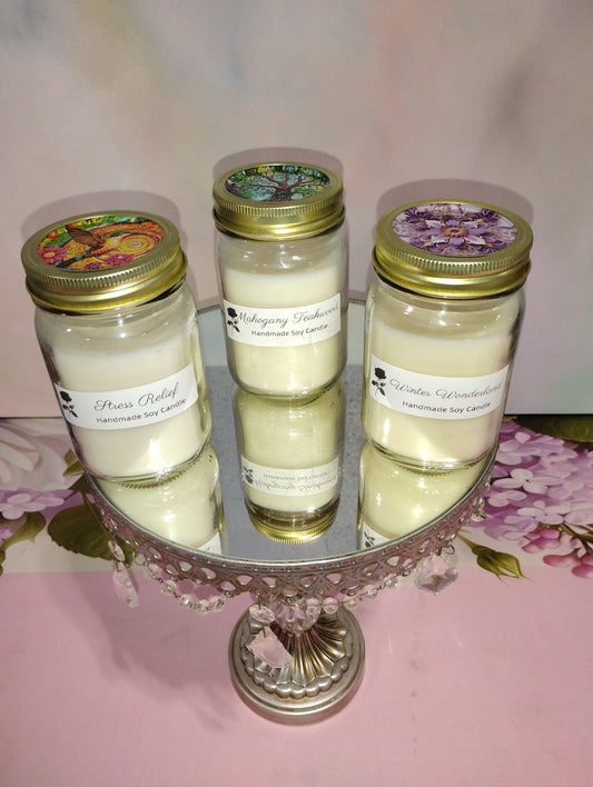 Handmade soy candles in glass jars with floral labels, featuring warm, inviting flames and decorative packaging.